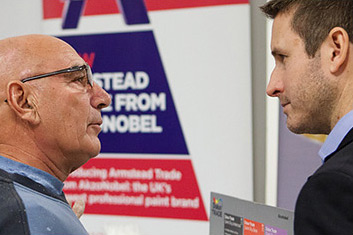 Two men speaking at a trade event