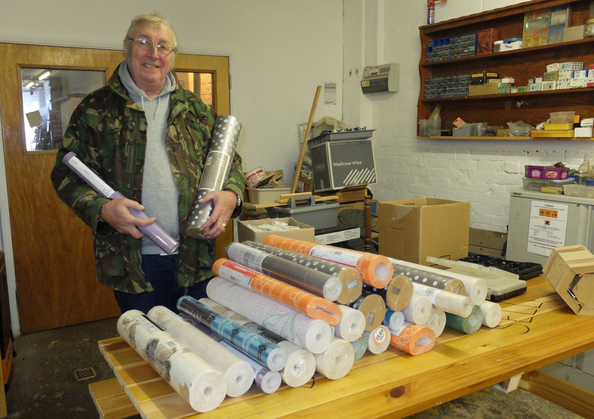 Ron Hall with wallpaper donated to HFS for The Decorating Skills workshop