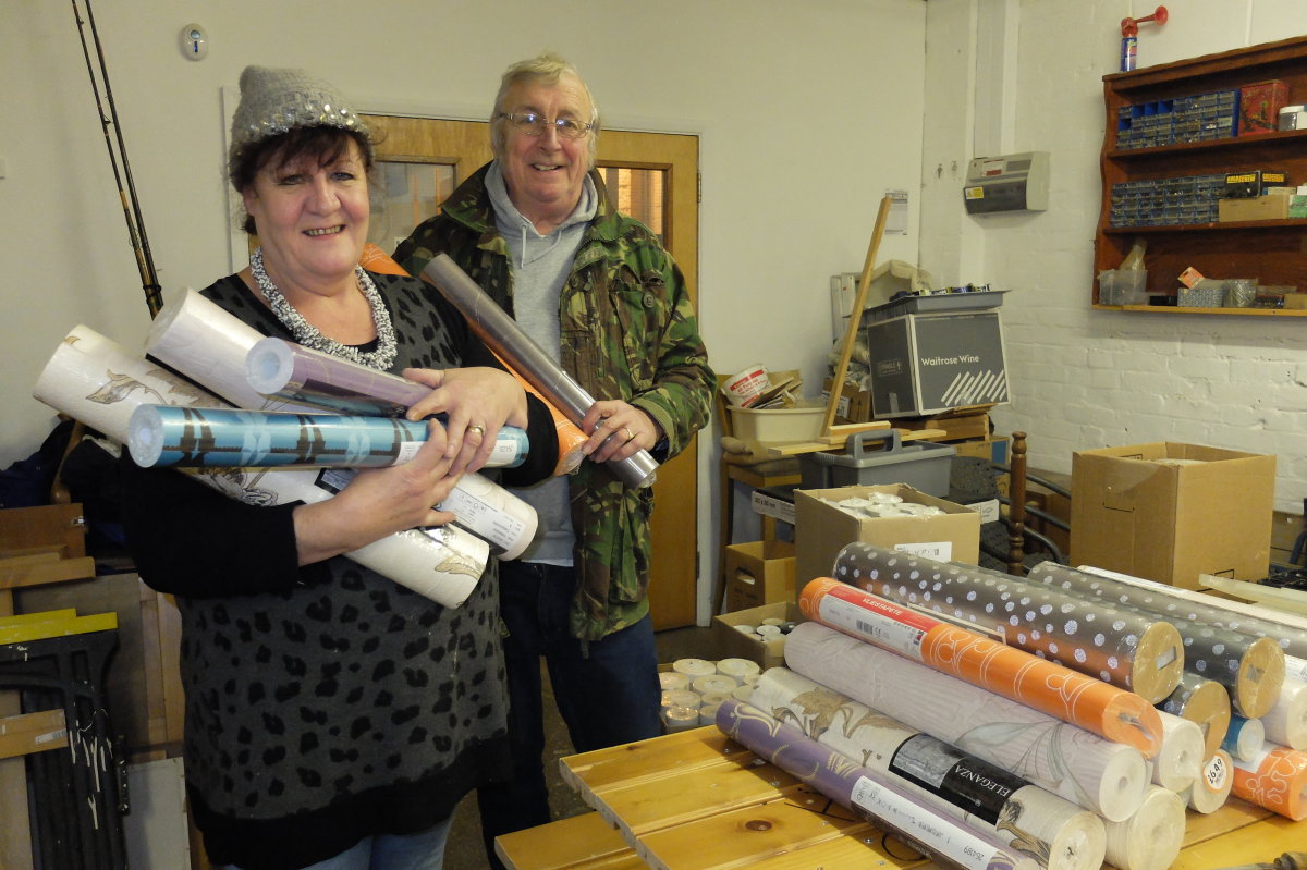 Ron Hal and Heidil with wallpaper donated to HFS for The Decorating Skills workshop