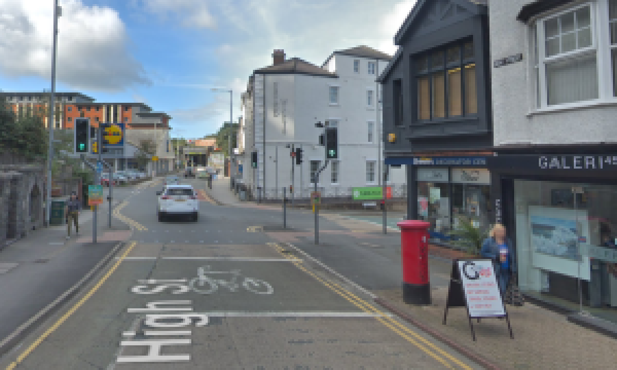 From Glanrafon on to the High Street, continue until you reach the junction with Farrar Road. The store is on the right hand corner.