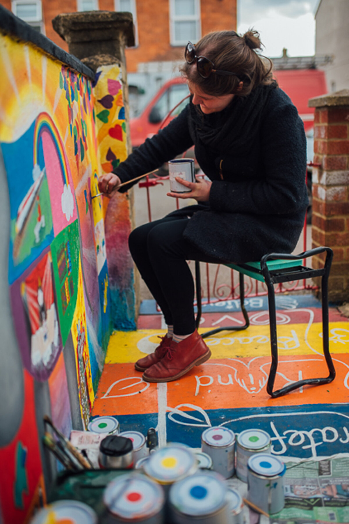 Sarah adding the finishing touches to the Mural of Joy