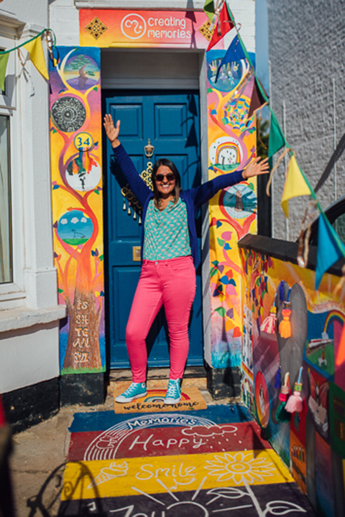 Pritti showing off the finished Mural of Joy