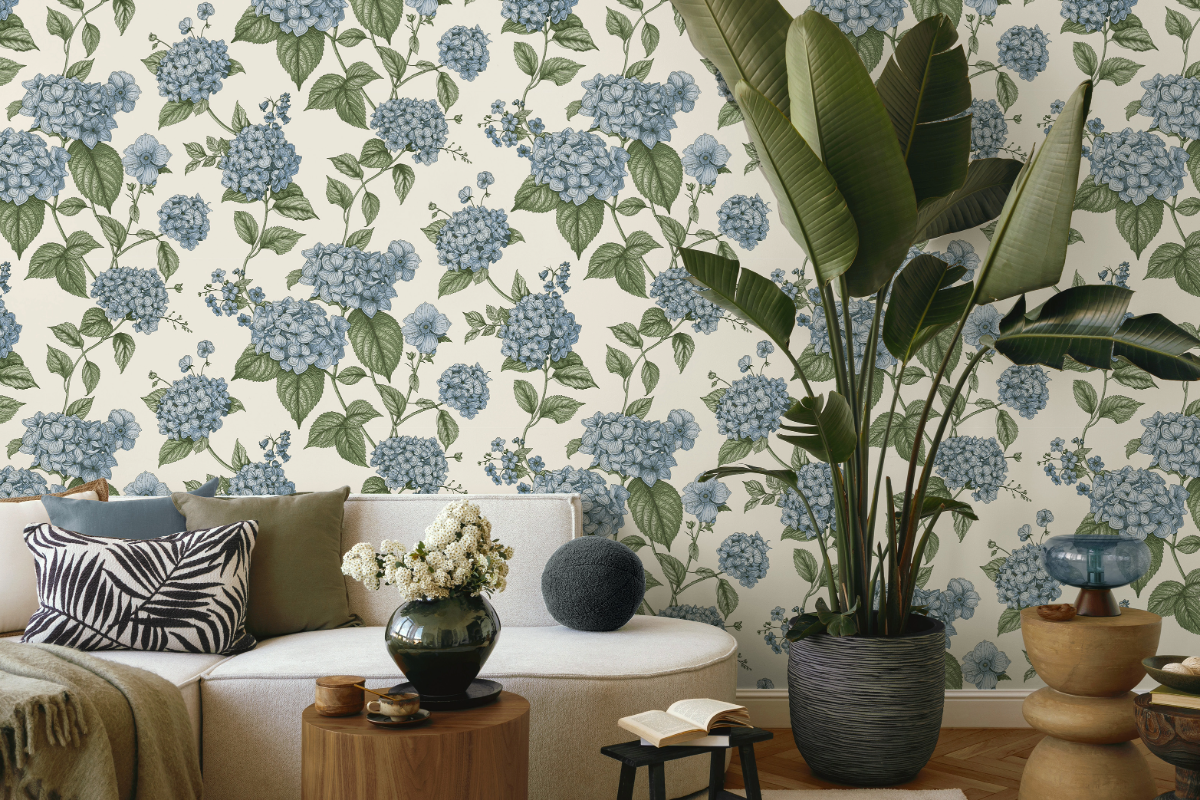Blue hydrangea wallpaper, a sofa and leafy plant in the foregrond