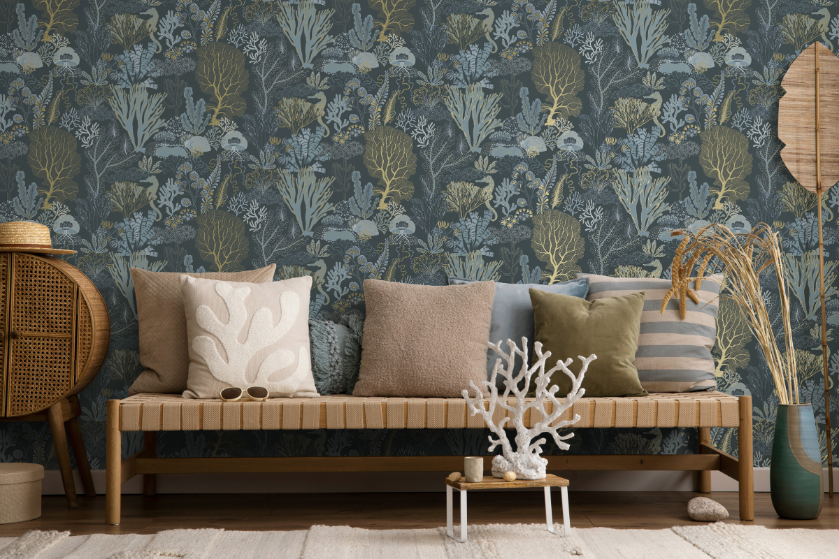Navy and gold coral pattern wallpaper with wooden bench and coral ornament in foreground