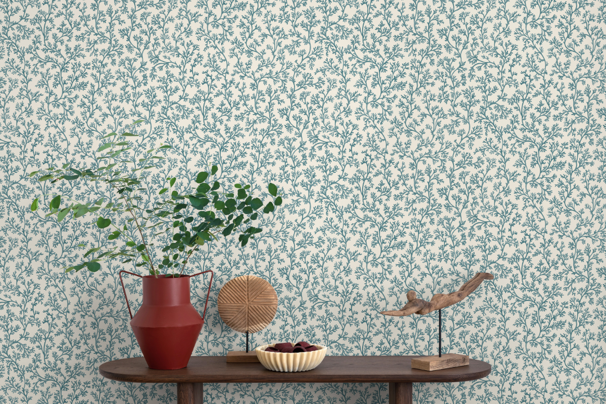 Blue weaving vine wallpaper with small table and plant in foreground