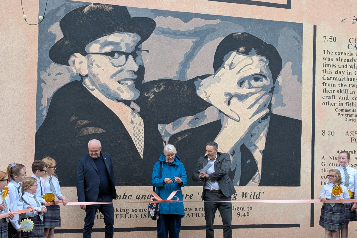 David Waddington, Morecambe Business Improvement District chair in front of the Eric Morecambe mural with Eric's children, Gary and Gail Morecambe