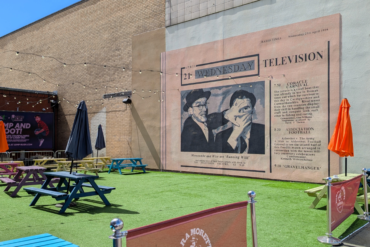 The Eric Morecambe mural on the side of the former Hitchens building