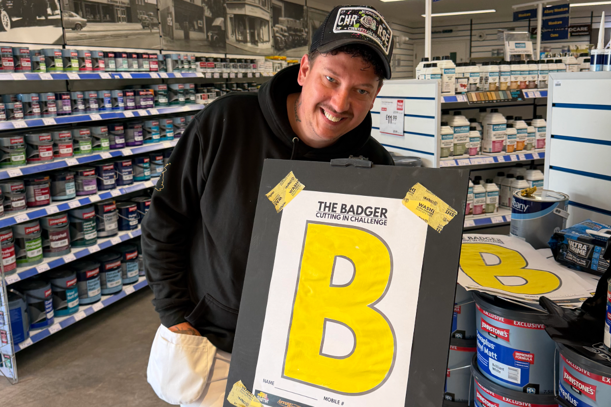 Kevin standing with the yellow 'B' cutting in board