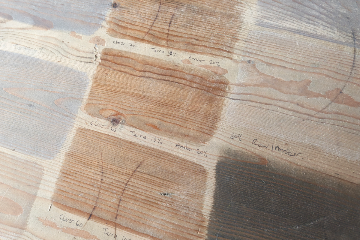 Testing Osmo Oil colours on a floorboard