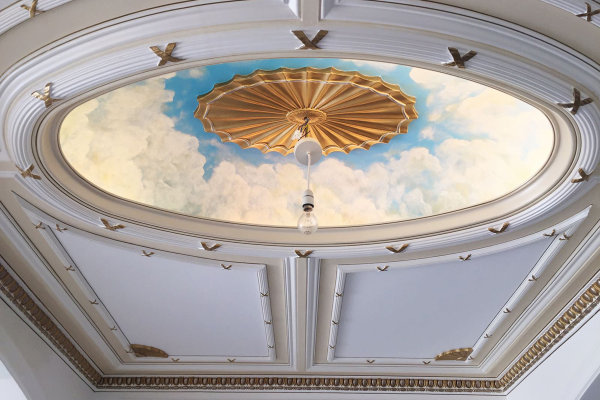 Beautifully detailed clouds and cherubs adorn grand spaces in this stunning stately home