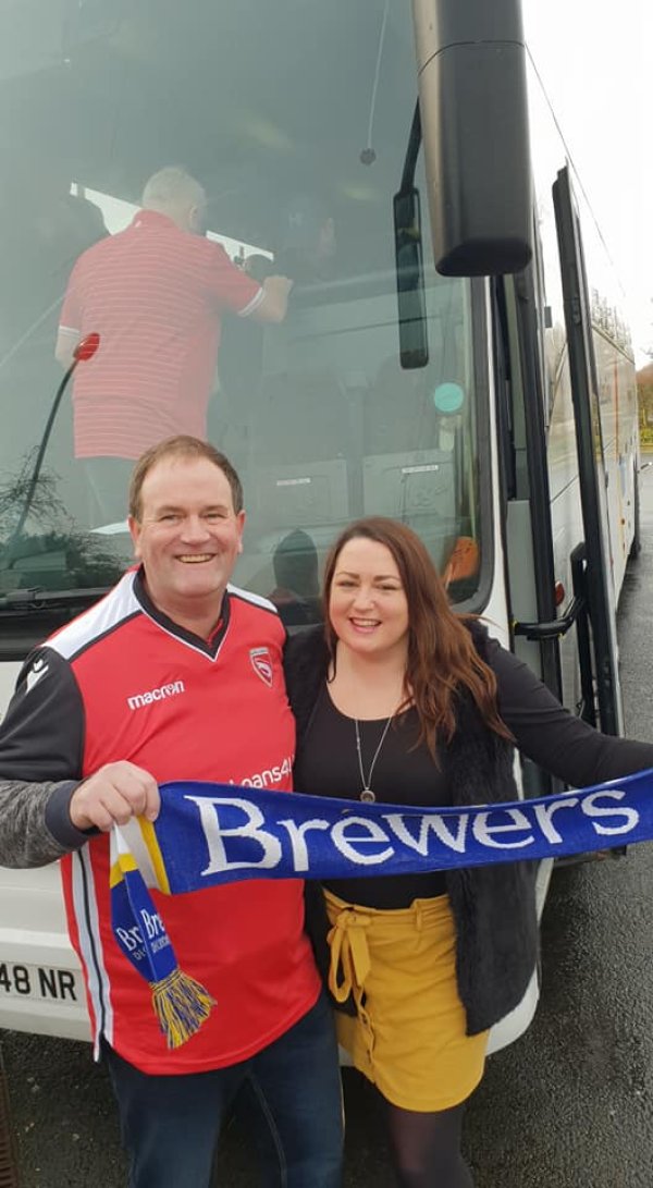 Football fans pose on the coach journey to watch Tranmere Rovers vs Morecambe